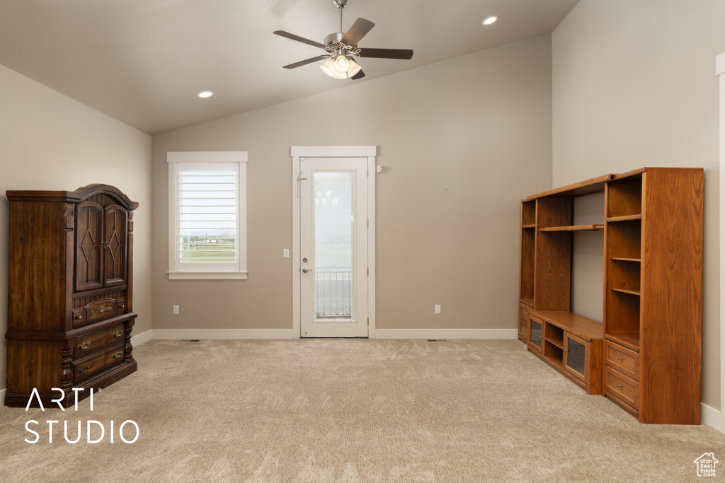Unfurnished living room featuring lofted ceiling, a ceiling fan, light colored carpet, and recessed lighting