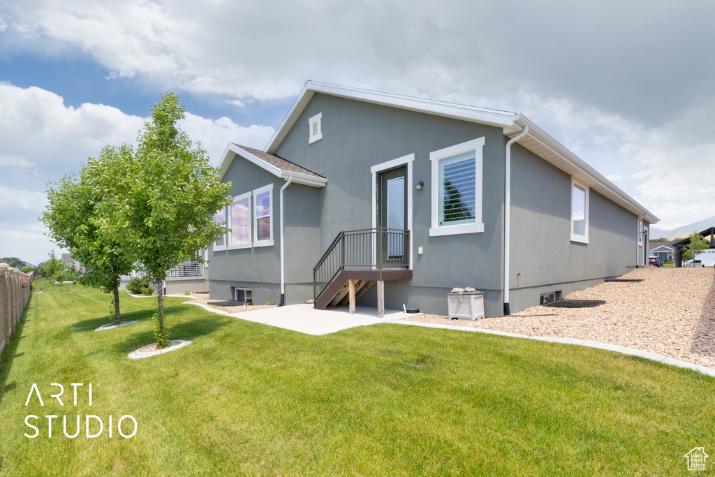 Rear view of house featuring a patio and stucco siding