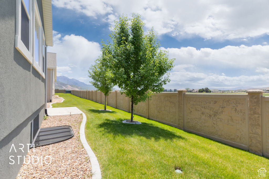 Fenced backyard featuring a mountain view