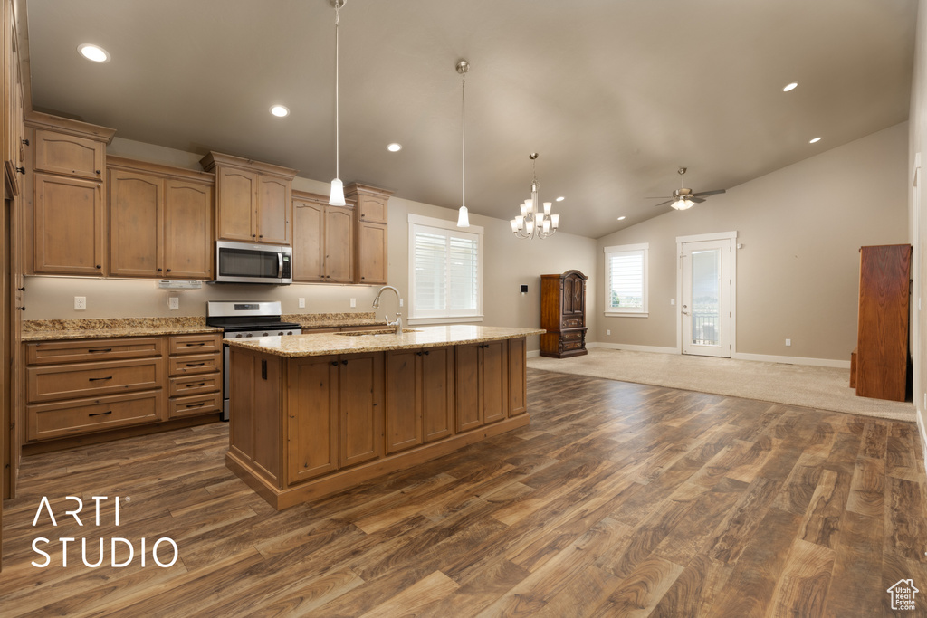 Kitchen with stainless steel appliances, dark wood-style flooring, ceiling fan, a kitchen island with sink, and vaulted ceiling