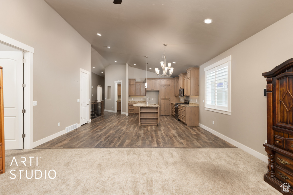 Kitchen featuring dark carpet, stainless steel electric range, a chandelier, recessed lighting, and vaulted ceiling