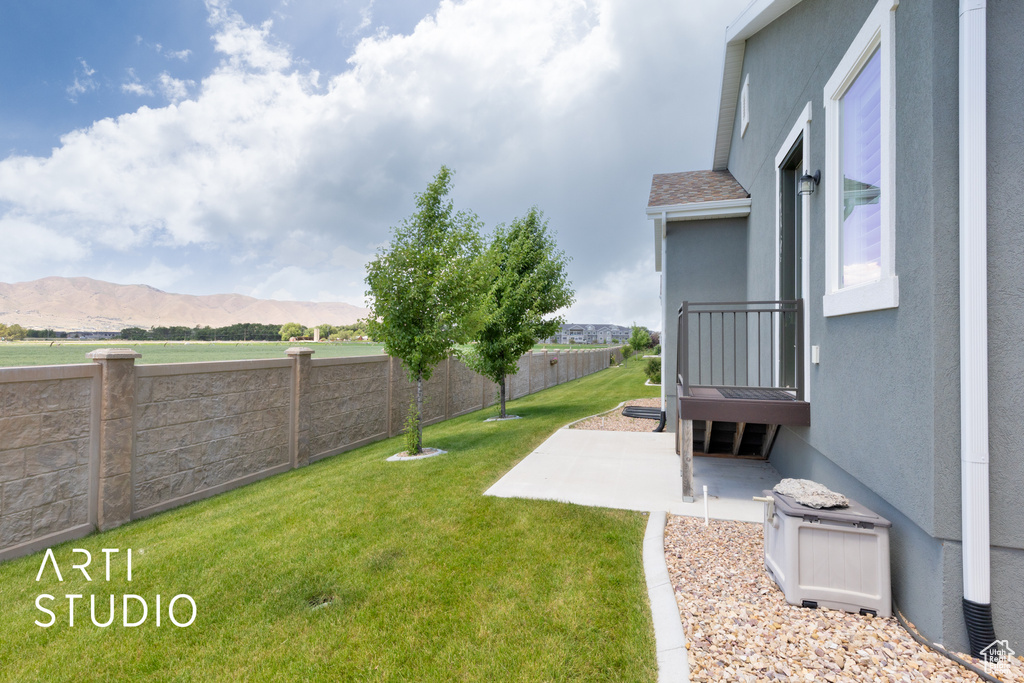 Fenced backyard with a patio and a mountain view