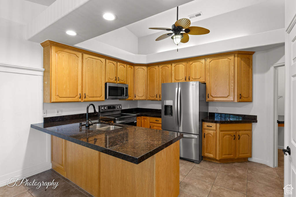 Kitchen featuring stainless steel appliances, a peninsula, ceiling fan, recessed lighting, and light tile patterned flooring
