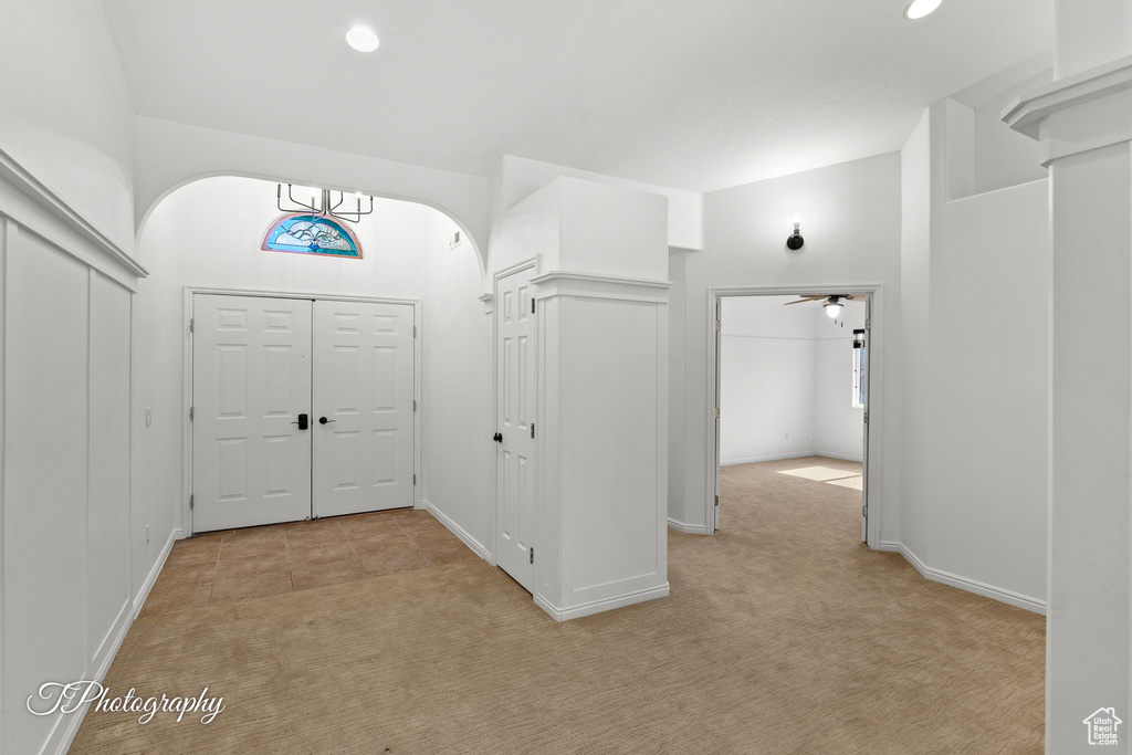 Foyer featuring light carpet and recessed lighting