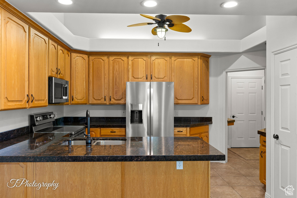 Kitchen featuring stainless steel appliances, a peninsula, recessed lighting, light tile patterned floors, and a ceiling fan