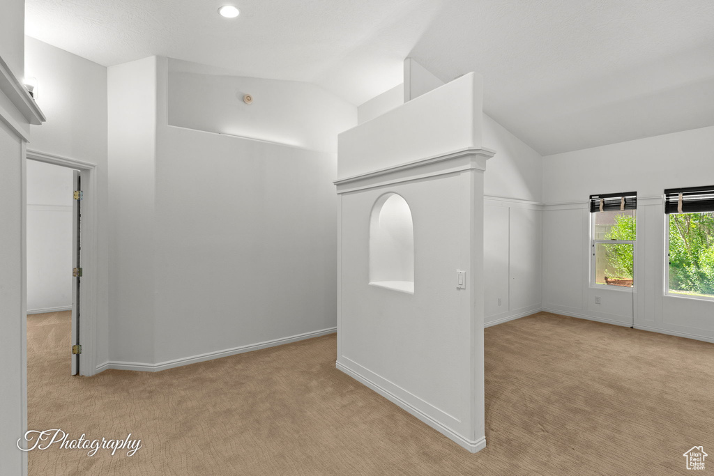 Spare room featuring carpet, lofted ceiling, and recessed lighting
