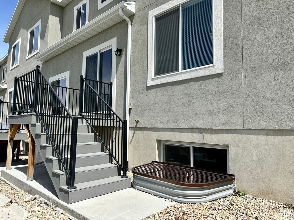 View of exterior entry featuring stucco siding