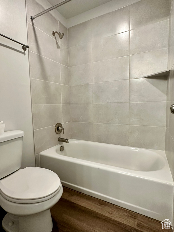 Full bath featuring wood finished floors and shower / bath combination