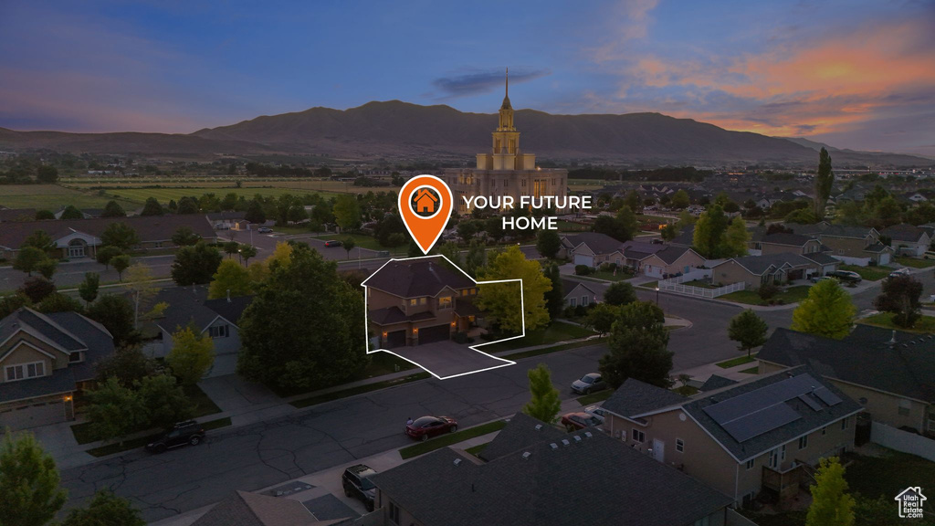 Aerial view at dusk of a mountain view, property boundaries highlighted, and a residential view