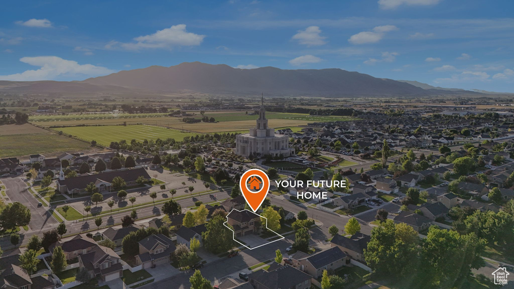 Aerial view of property and surrounding area with a mountain backdrop
