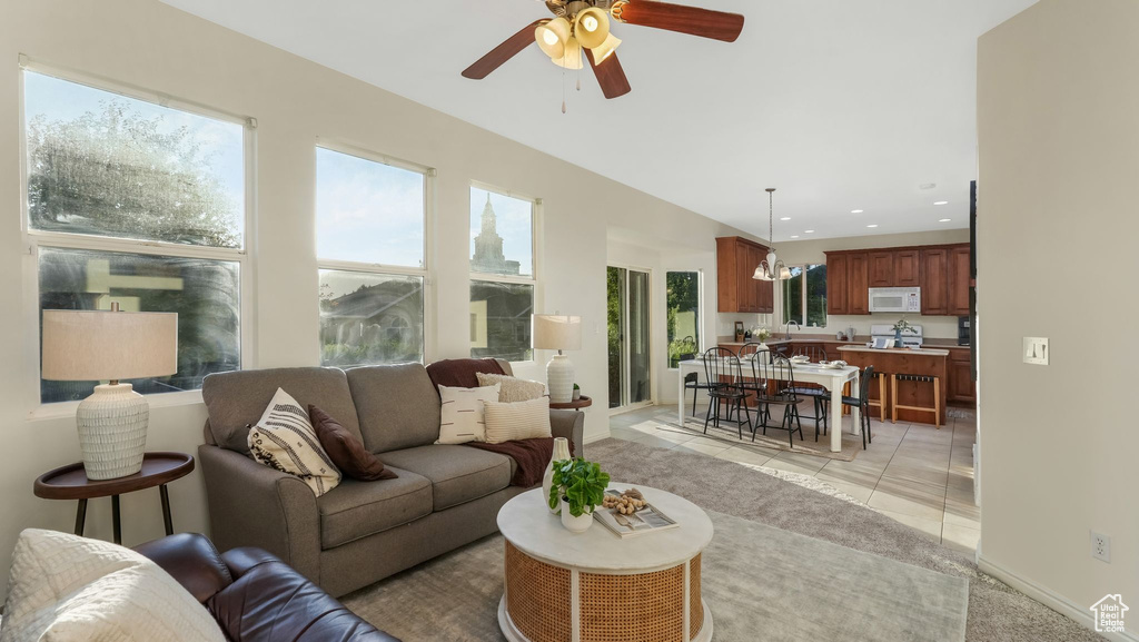 Living area with ceiling fan, recessed lighting, and light tile patterned floors