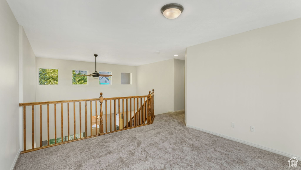 Unfurnished room with carpet floors and a ceiling fan