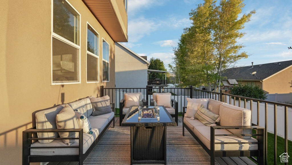 Wooden deck with an outdoor living space with a fire pit
