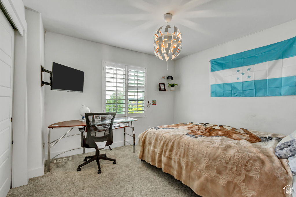 Bedroom featuring carpet floors and a chandelier