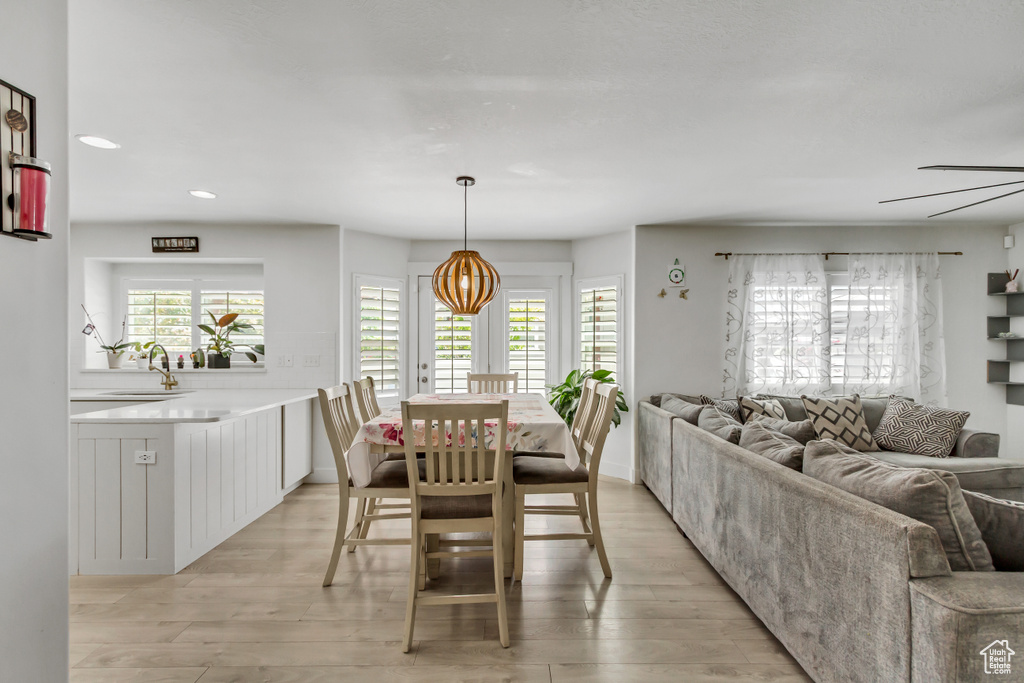 Dining room featuring light wood-style flooring, recessed lighting, and a ceiling fan