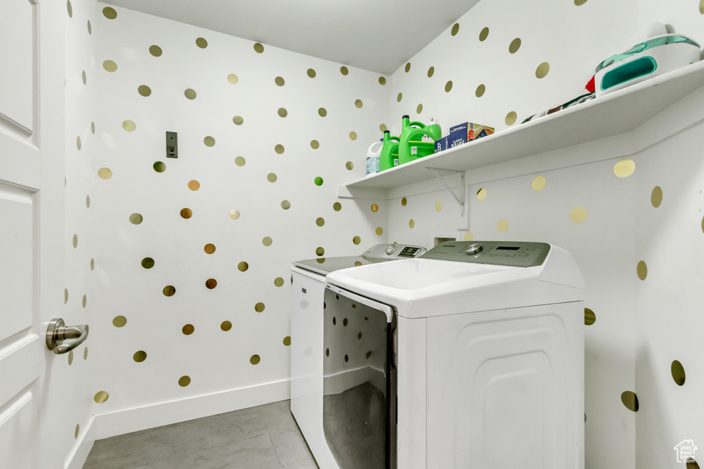 Washroom with separate washer and dryer and wallpapered walls