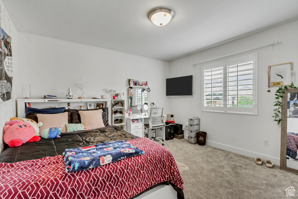 Carpeted bedroom featuring baseboards