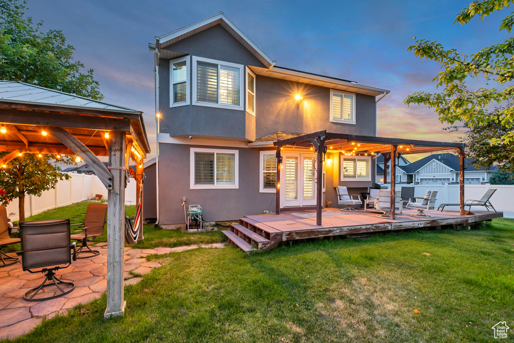 Back of property with a deck, stucco siding, and french doors