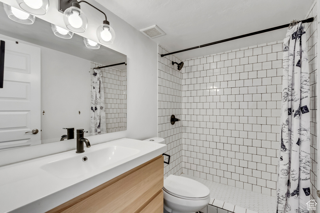 Full bathroom featuring vanity and a tile shower