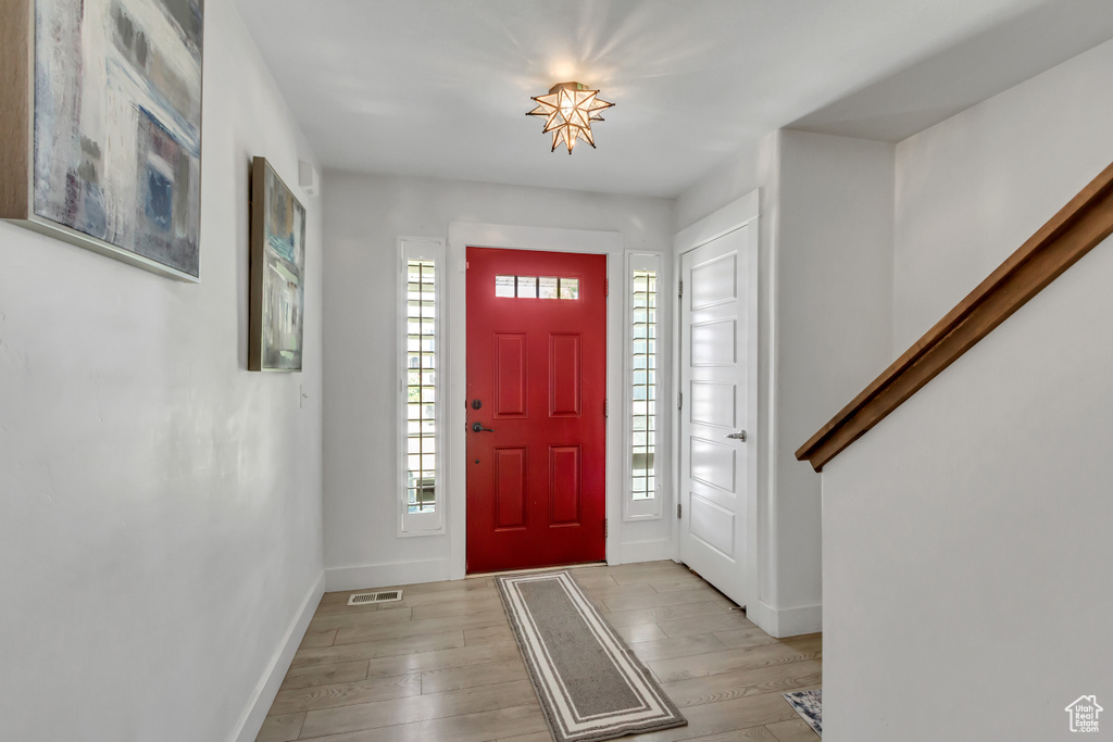 Entrance foyer featuring healthy amount of natural light and light wood-style floors
