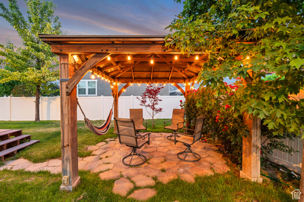 Fenced backyard featuring a gazebo and a patio