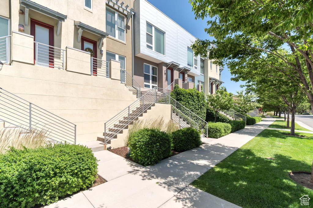 View of home's community with stairway, a residential view, and a yard