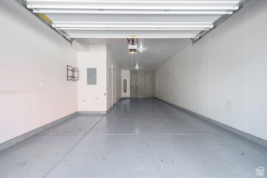 Garage with electric panel and a garage door opener