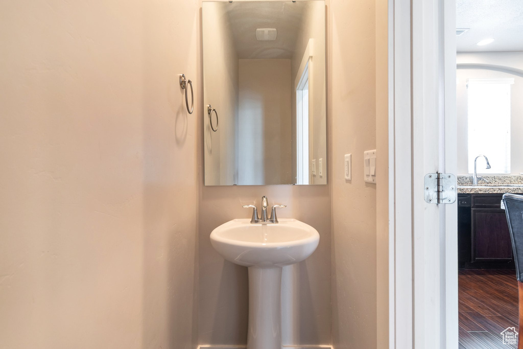 Bathroom featuring a sink and wood finished floors