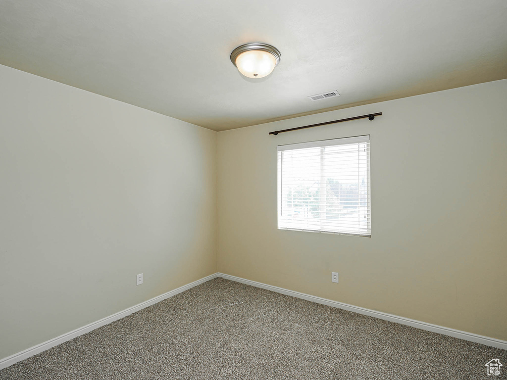 Unfurnished room with carpet flooring and baseboards