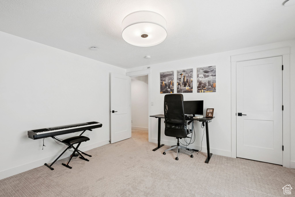 Office with light carpet and baseboards