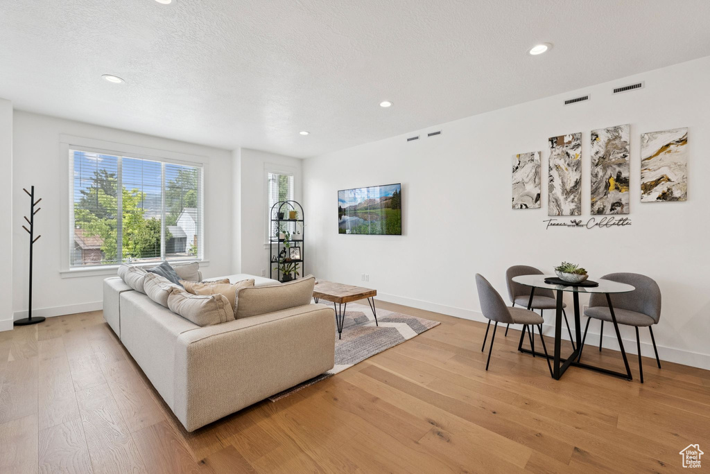 Living room with wood finished floors and recessed lighting