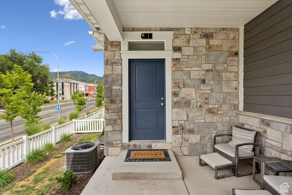 Property entrance with stone siding and a mountain view