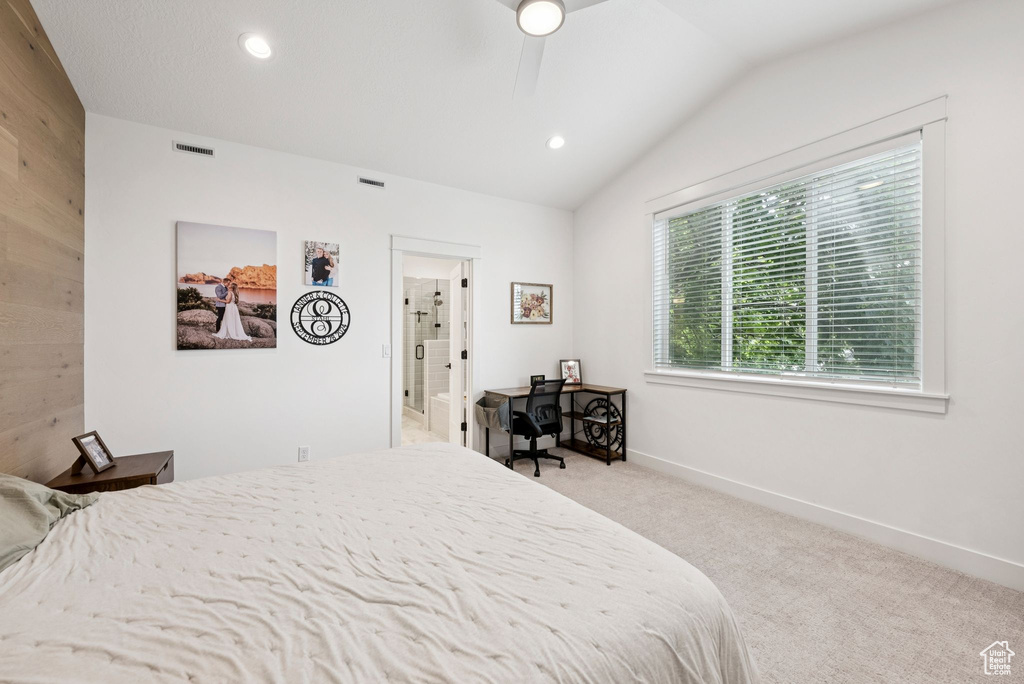 Carpeted bedroom with vaulted ceiling, recessed lighting, ensuite bathroom, and a ceiling fan