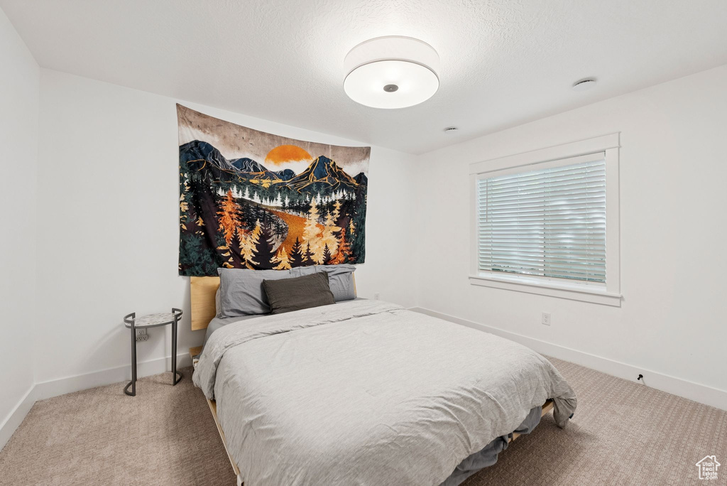 Carpeted bedroom featuring baseboards