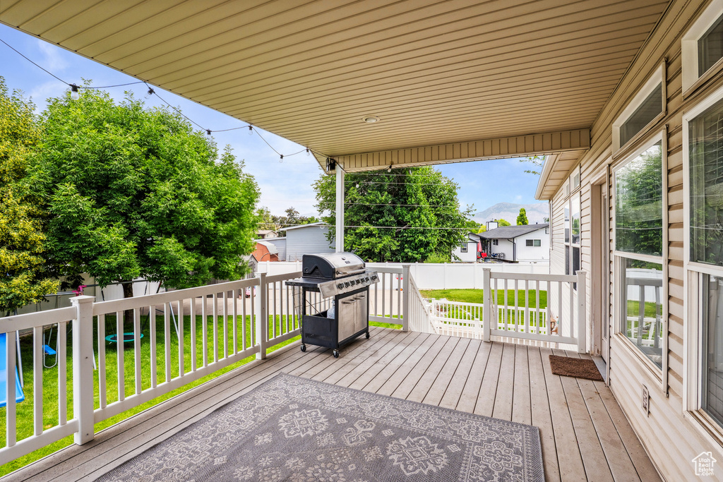 Deck with a fenced backyard and a grill