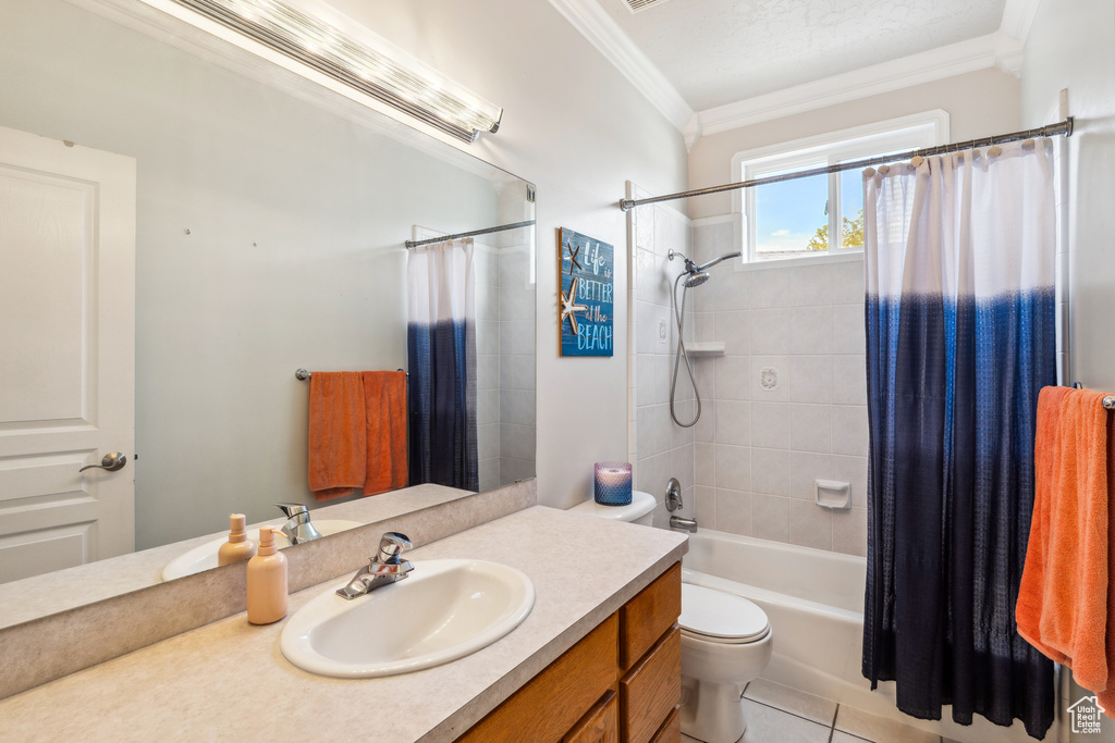 Full bath featuring crown molding, vanity, shower / bath combo, and tile patterned floors