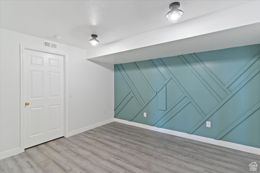 Empty room with baseboards and wood finished floors