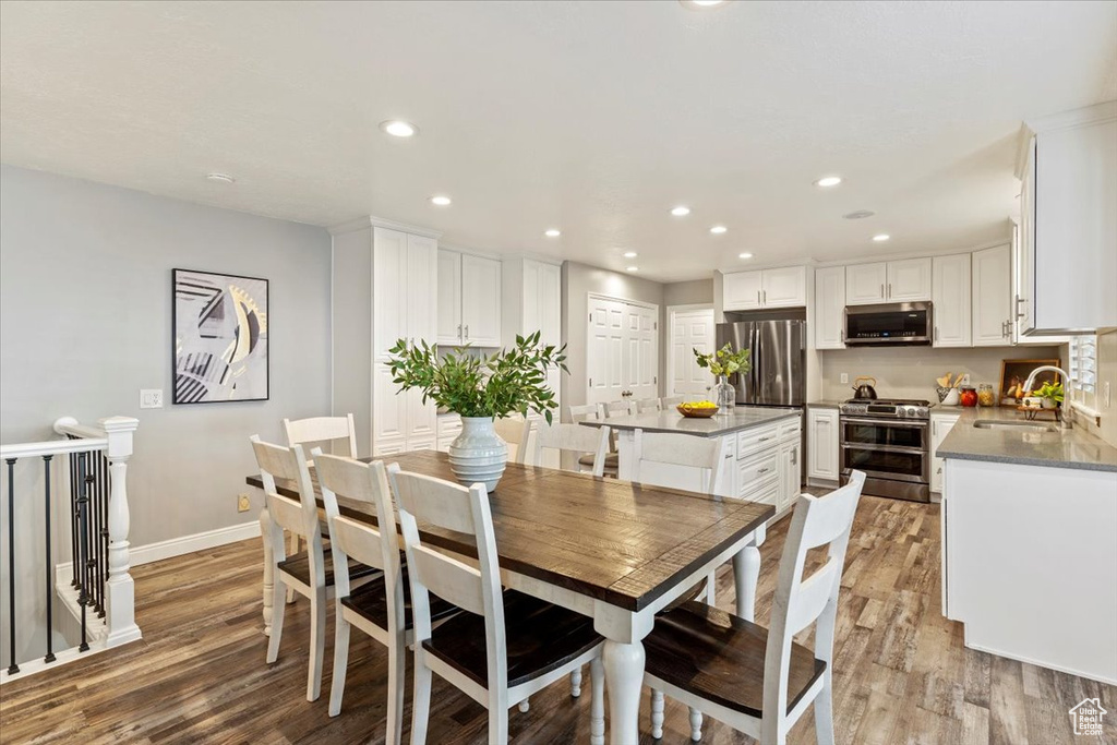 Dining space with light wood-style flooring and recessed lighting