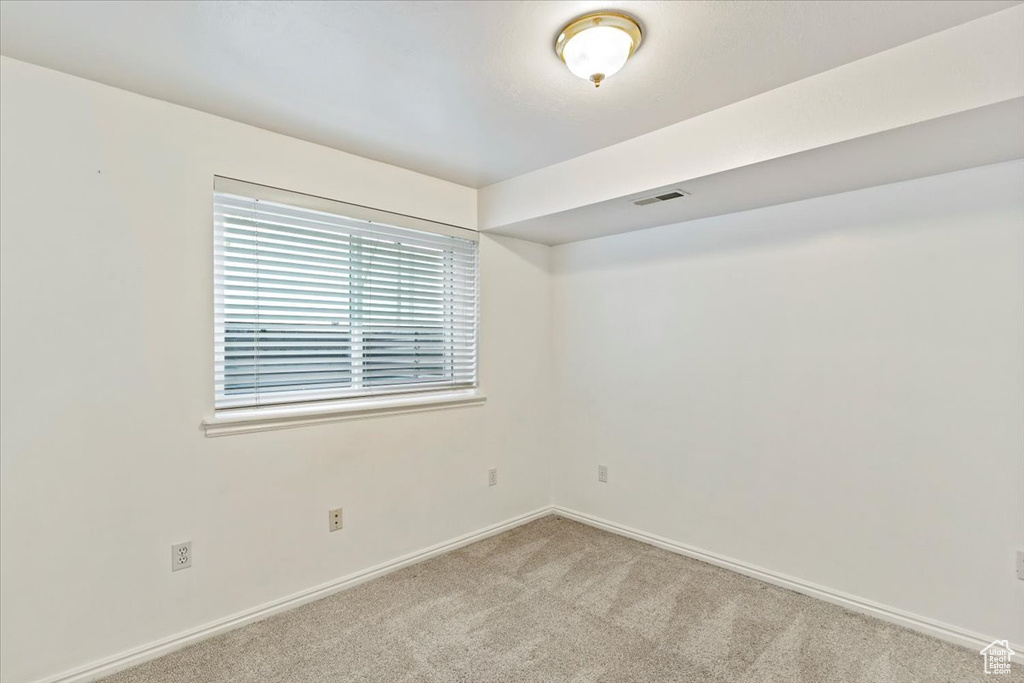Spare room with carpet floors and baseboards