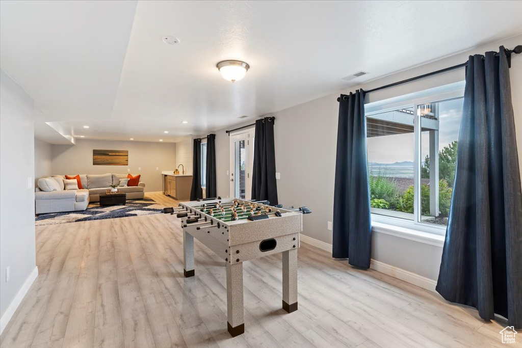 Game room with light wood finished floors and recessed lighting