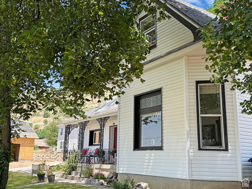 View of side of home with covered porch