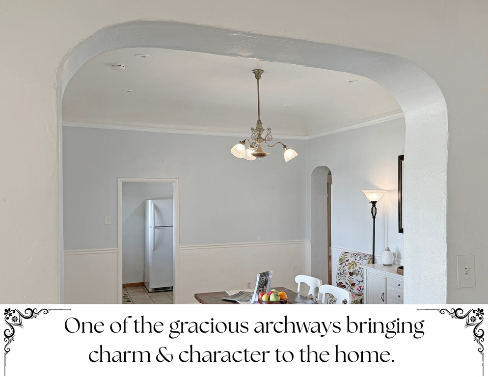 Interior space with arched walkways, crown molding, and a chandelier