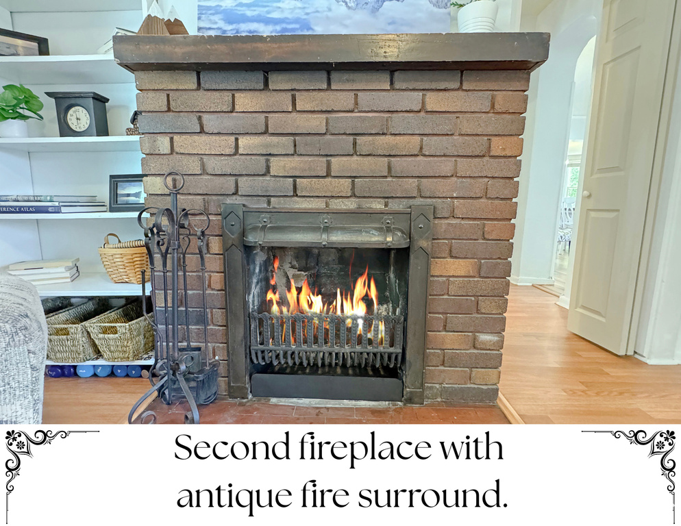 Detailed view of a brick fireplace, wood finished floors, and arched walkways