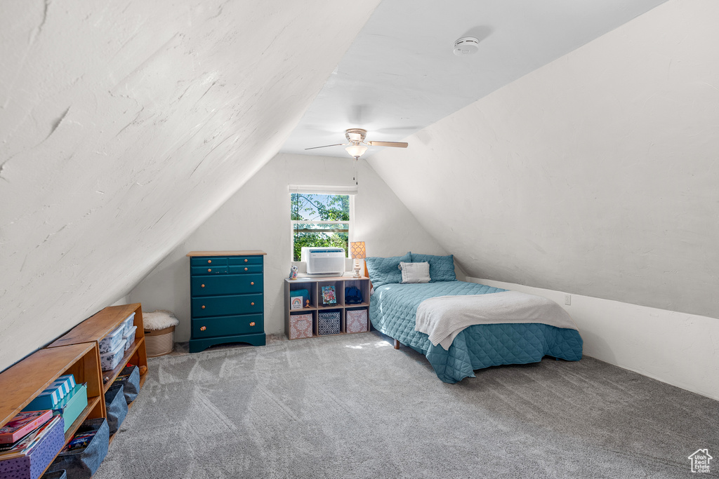 Bedroom featuring lofted ceiling, carpet floors, and a ceiling fan