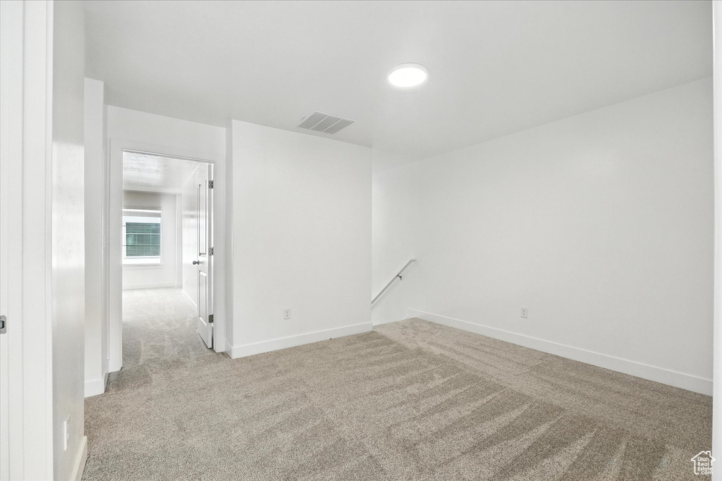 Carpeted spare room with baseboards