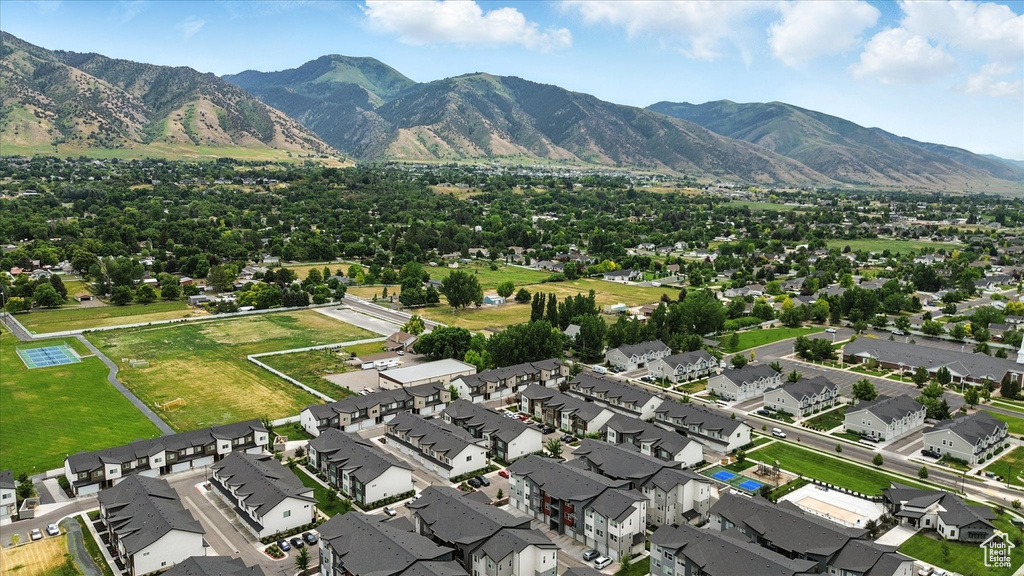 Aerial overview of property's location with nearby suburban area and a mountain backdrop
