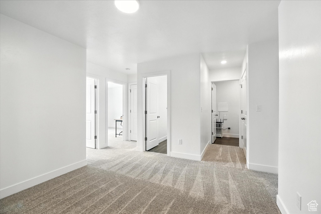 Carpeted spare room featuring baseboards and recessed lighting