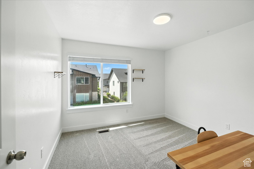 Unfurnished room featuring carpet flooring and baseboards