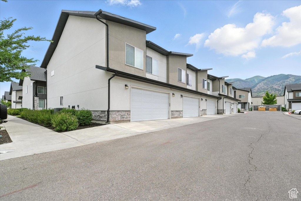 View of asphalt road featuring a mountain view and a residential view
