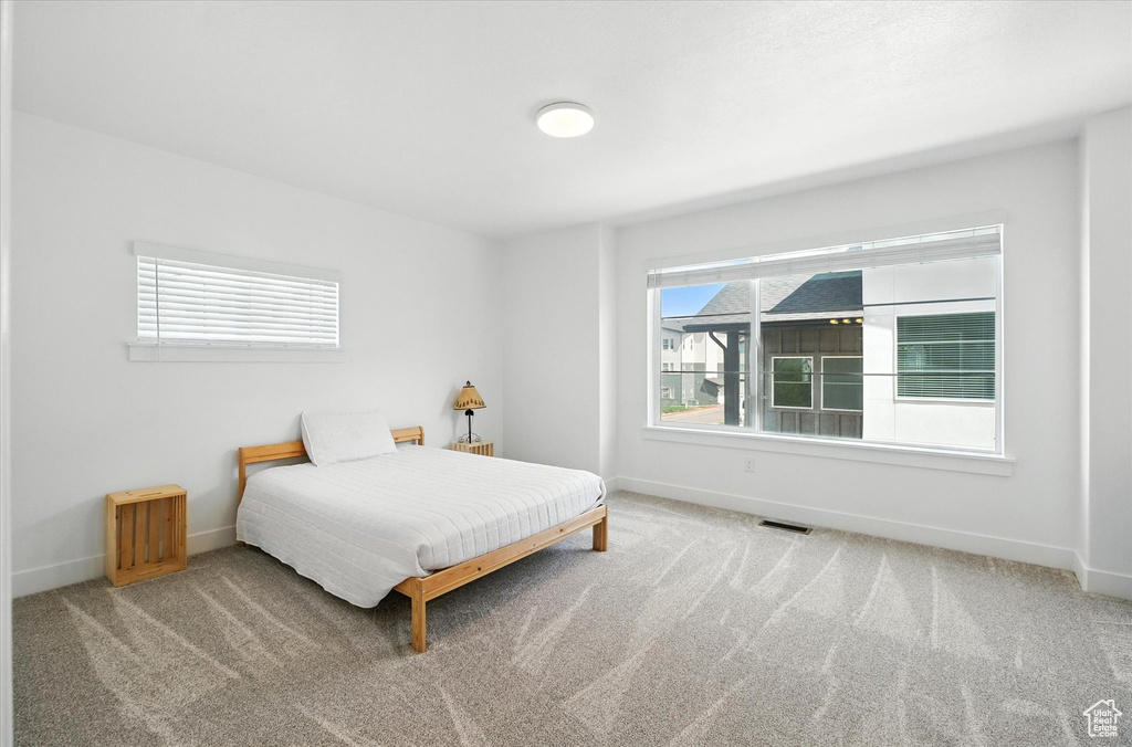Carpeted bedroom with baseboards
